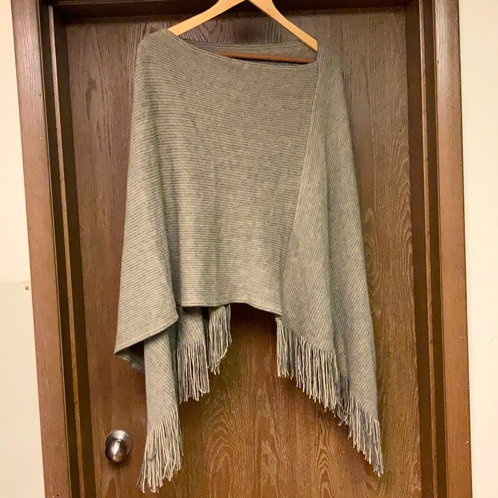 Beige sweater poncho with fringe
